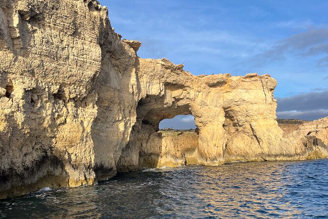 Blue Lagoon Ferry and Caves Tour - Meeting beneath the blue umbrella at Mgarr