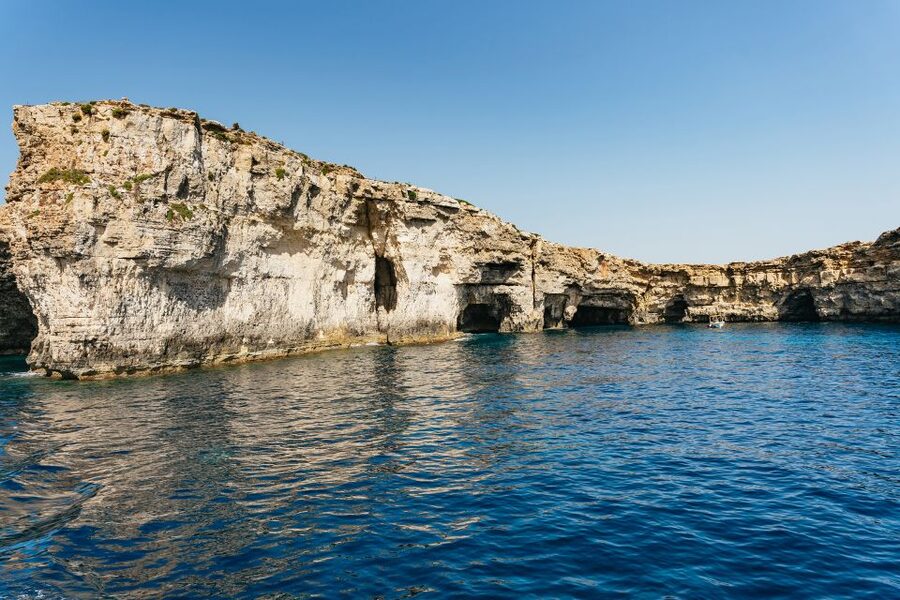Comino: Blue Lagoon, Crystal Lagoon, and Seacaves Tour - Blue Lagoon: beautiful water, busy shoreline