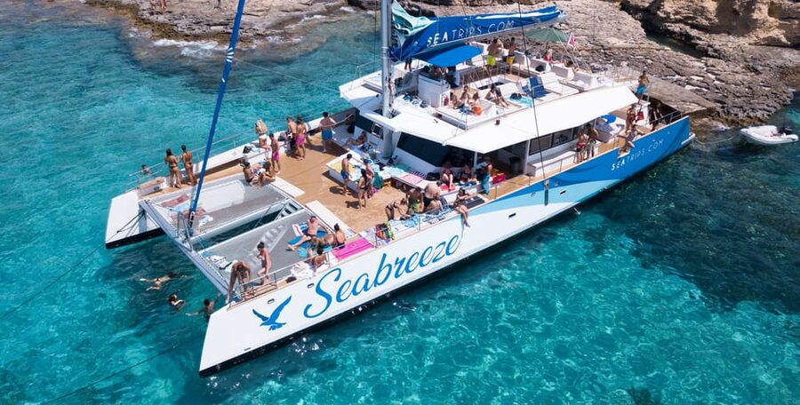 Malta: Blue Lagoon Evening Catamaran Cruise - Sunset, cocktails, and music on the return